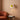 Swivel Shade Plug-In Wall Lamp | Wood and Metal Reading Sconce – switched on in a room