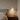 Travertine and Glass Globe Pendant Light | Stone and Wood Island Light – switched on in a room