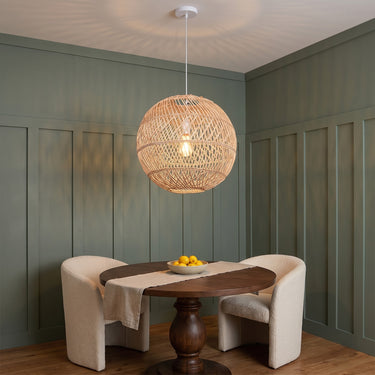 Banded Rattan Globe Pendant Light | Natural Woven Hanging Lamp – switched on in a room