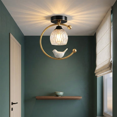 Ceramic Bird Brass Ceiling Light | Whimsical Glass Bud Flush Fixture – switched on in a room
