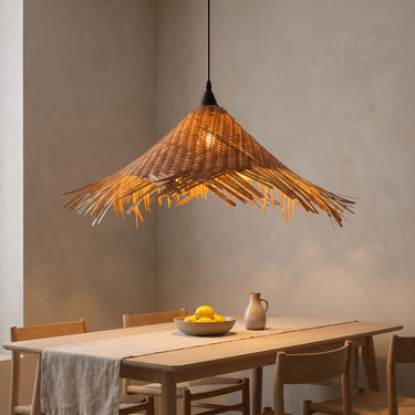 Fringed Bamboo Cone Pendant Light | Woven Chevron Hanging Lamp – switched on in a room