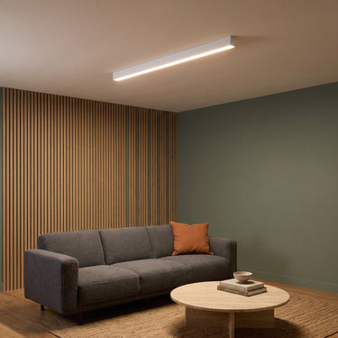 Long Wood-Look Linear Ceiling Light | Slim Bar with Remote Dimming – switched on in a room