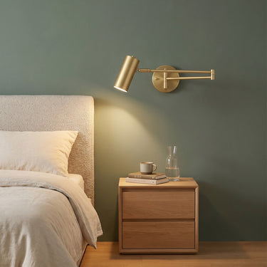 Slim Pivoting Arm Wall Sconce | Swivel Reading Light in Gold or Black – switched on in a room