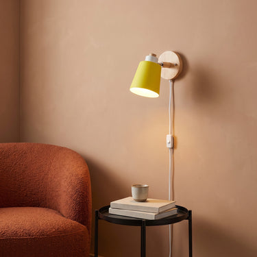 Swivel Shade Plug-In Wall Lamp | Wood and Metal Reading Sconce – switched on in a room