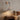 Textured Wood Wall Sconce | Natural Mid-Century Wall Light – switched on in a room