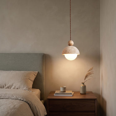 Travertine and Glass Globe Pendant Light | Stone and Wood Island Light – switched on in a room
