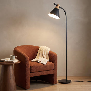 Wood-Accent Metal Cone Floor Lamp | Curved Nordic Standing Light – switched on in a room